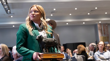 National Junior Angus Association Director Lexi Koelling holds a historic bronze bull statue cast by artist Jim Reno and donated to the Angus Foundation’s live auction by past American Angus Association CEO Jim Crouch. The Angus Foundation raffle and Awards Dinner auction, during the 2025 Angus Convention in Kansas City, Mo., collectively raised $37,320 to support education, youth and research.