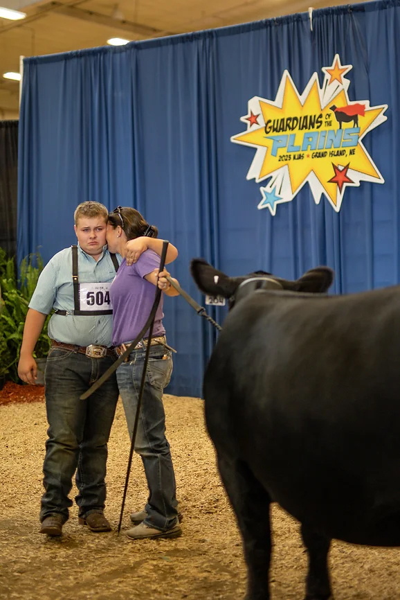 family hugging at cattle show