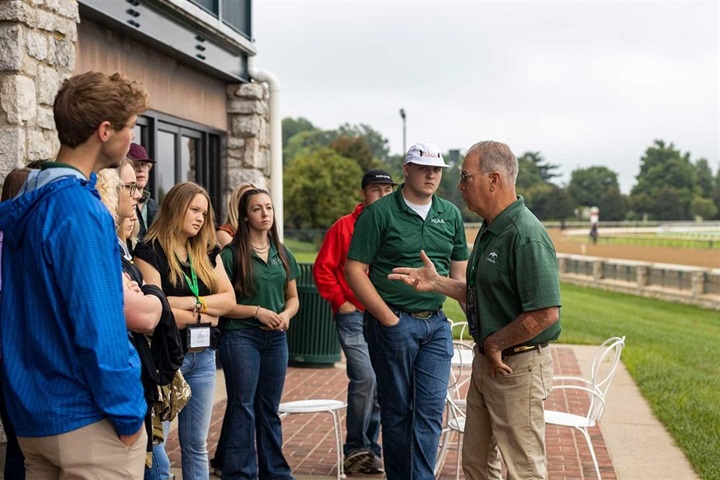A group of NJAA junior youth listening to a speaker at a educational stop on a tour.