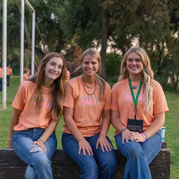 Three girls smiling at LEAD event.