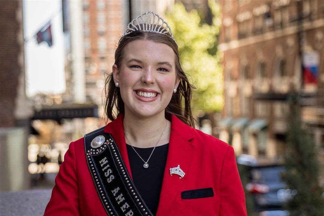 Claire Murnin, the 2026 Miss American Angus, stands smiling in her iconic red blazer.