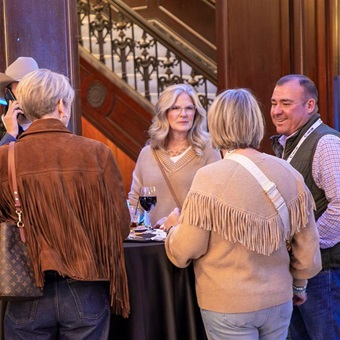 A group of breeders stand and chat.