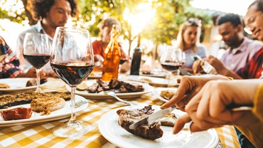 people at a table eating beef