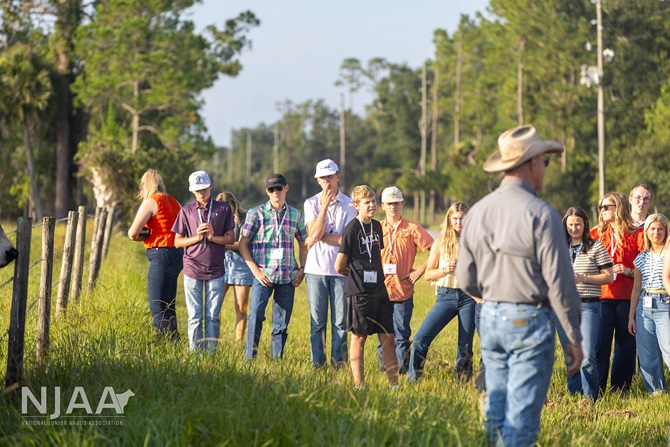Participants touring pastureland during a ranch visit.
