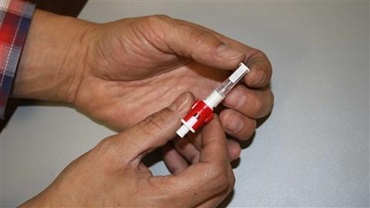 Person holding a tissue sample collection