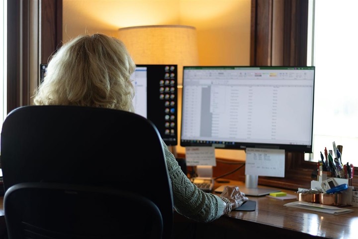 Woman sitting at a desk working on her computer