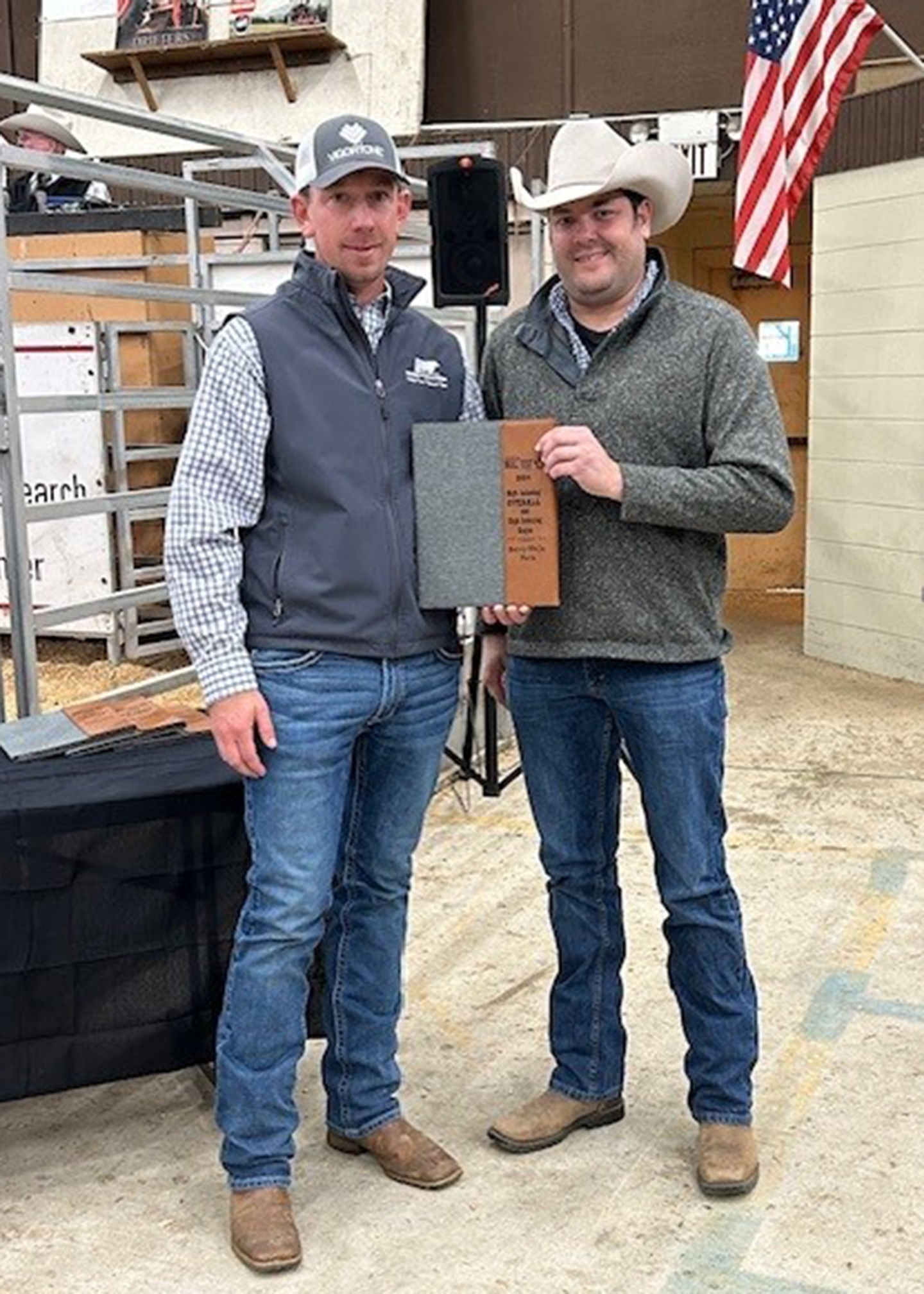 Berry-Wells Farm, Rayle, Ga., consigned the high-indexing Angus bull and overall high-indexing bull at the 2024 Calhoun Bull Evaluation Performance Test and Sale Dec. 6 in Calhoun, Ga. Wells Rogers W329 is a Sept. 2023 son of Kenny Rogers. He posted an ADG of 6.56 lb. with an adjusted yearling weight of 1,523 lb. Pictured (from left) are Johnathan Wells, Rayle, Ga., recipient; and Dale Sandlin, Georgia Cattlemen’s Ass’n executive vice president, presenting. 