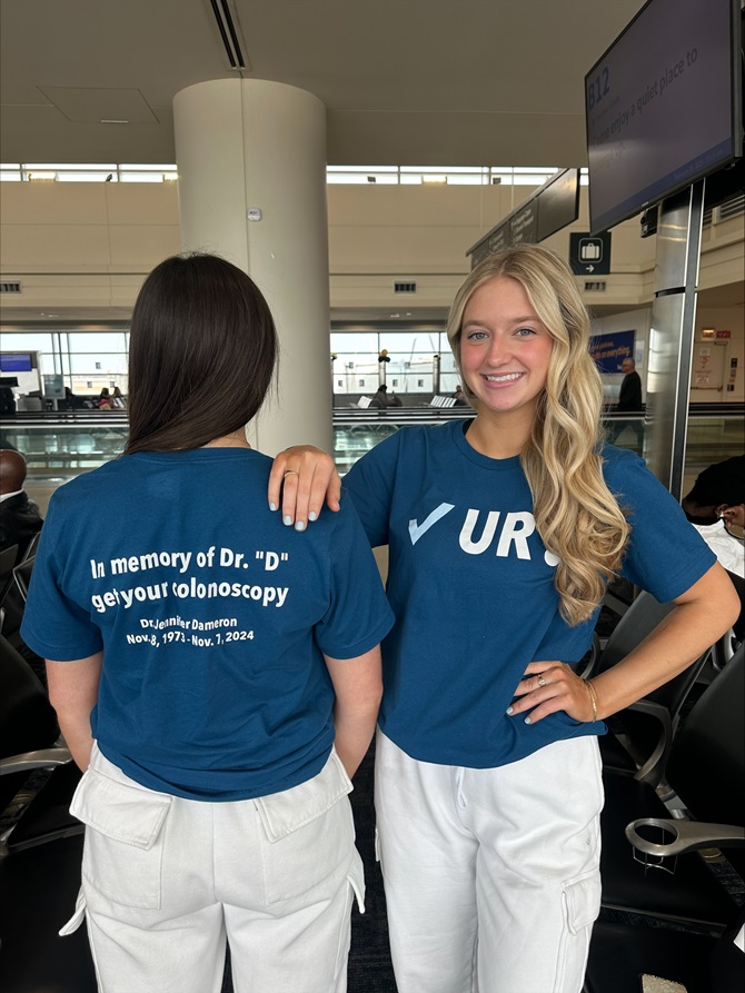Anne Dameron, NJAA Junior Board Member stands in an airport showing off her "Check your colon" t-shirt.