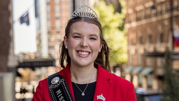 Claire Murnin, the 2026 Miss American Angus, stands smiling in her iconic red blazer.