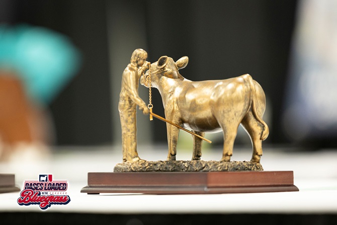 Bronze showmanship trophy featuring a young cattle exhibitor leading a steer on display at the NJAS silent auction.