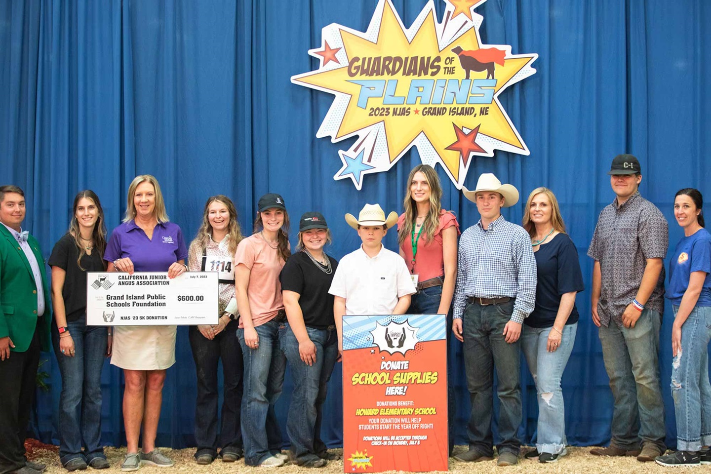 Members of the California Junior Angus Association pose with J. Gordon Clark, far left, of the National Junior Angus Association board of directors and Grand Island Public Schools representative Jennifer Worthington, who is holding the donation check.