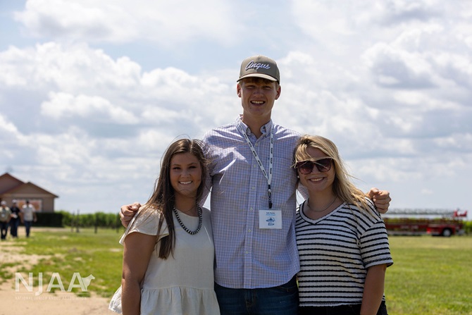 Three NJAA participants posing outdoors during a farm tour.
