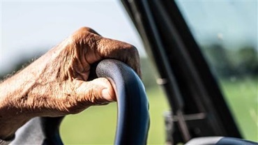 Hand on steering wheel