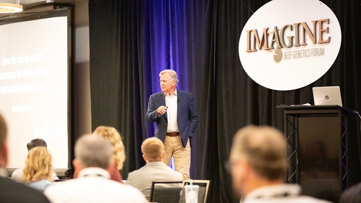A speaker giving a presentation at the AGI Imagine: Beef Genetics Forum