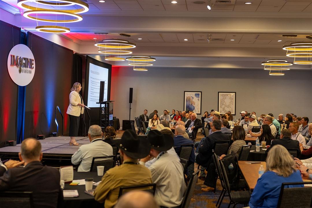 Kelli Retallick-Riley, president of Angus Genetics Inc. (AGI®), welcomes attendees to the second day of Imagine: AGI’s Beef Genetics Forum in August in Kansas City.