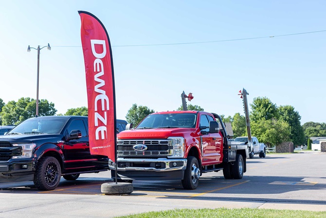 Red truck with a Deweze sign banner.