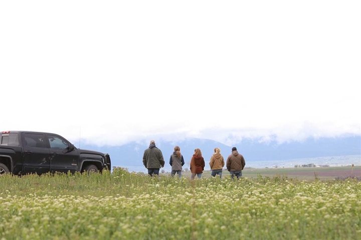 Family standing in pasture.