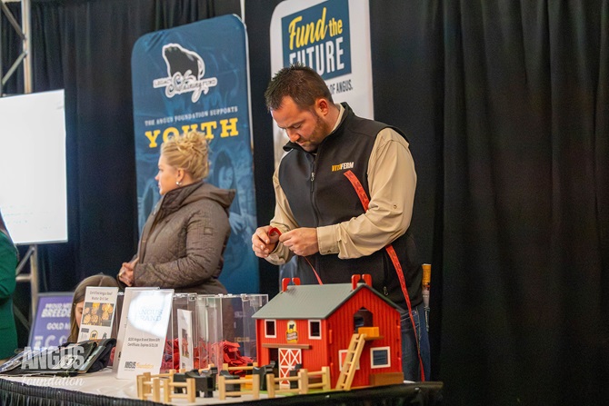 An individual inspects the items available at the Angus Foundation silent auction at Cattlemen's Congress in 2026.