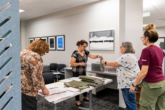 A group of American Angus staff counting ballots during membership voting.