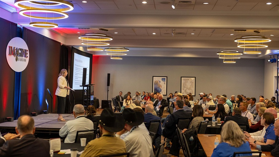 Kelli Retallick-Riley, president of Angus Genetics Inc. (AGI®), welcomes attendees to the second day of Imagine: AGI’s Beef Genetics Forum in August in Kansas City.