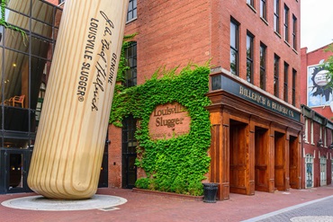 A brick building featuring the Louisville Slugger logo.