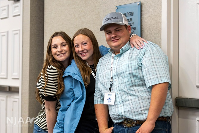 Three NJAA participants posing together indoors.