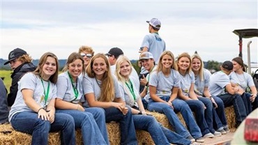 Group of kids having fun on a hay ride.