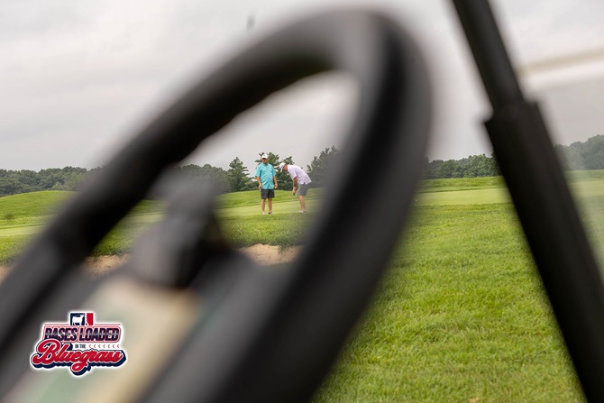 Golfers read the green and discuss their next putt during tournament play.
