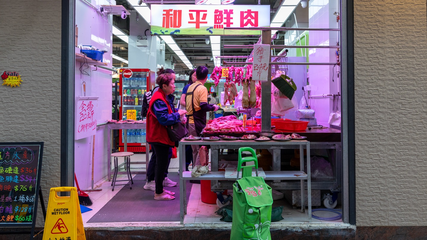 People at a butcher shop in To Kwa Wan, Kowloon, Hong Kong.