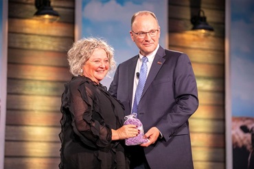 American Angus Association CEO, Mark McCully, grants an award to an attendee at the American Angus Convention.