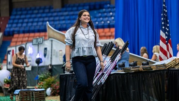 With a smile, Rosalind Kidwell of Gentryville, Indiana is recognized during the closing awards ceremony at the National Junior Angus Show in Tulsa, Oklahoma, marking the culmination of hard work and dedication throughout her junior career. 