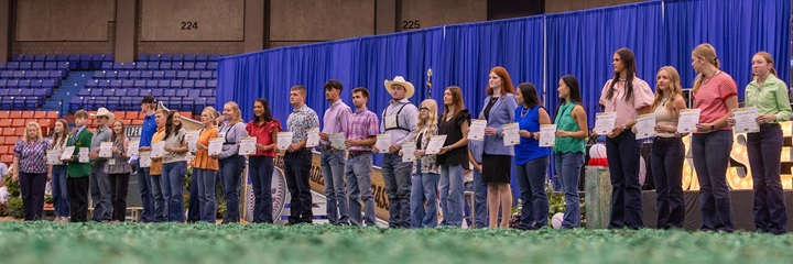 Recipients pose with Angus Foundation scholarship certificates during the scholarship presentations at the National Junior Angus Show.