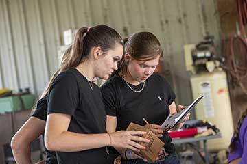 Crisp County Girls teammates Cora Crews and Mailee Dean fill out the processing map.