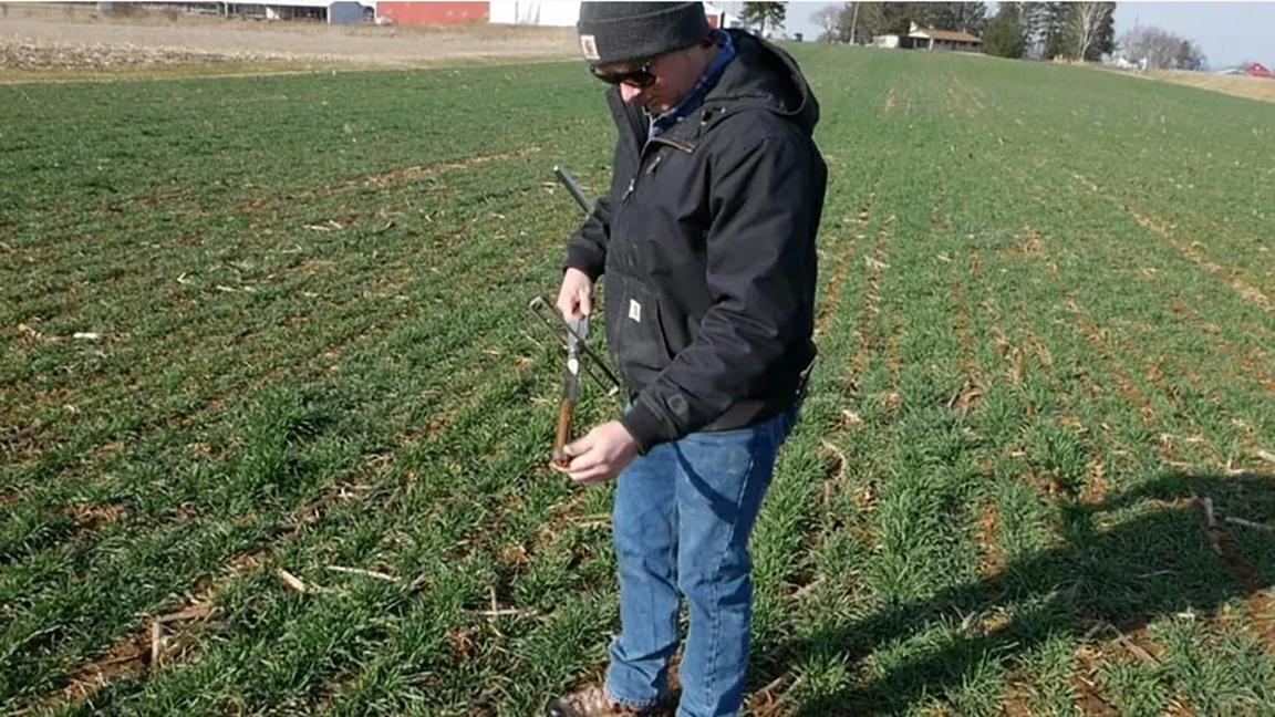 Collecting a soil sample for fertility analysis (Photo: Charlie White)