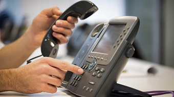 Person dialing a phone.