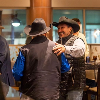 Old friends meeting together for an embrace at Angus Convention.
