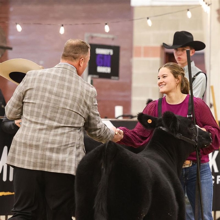 A livestock judge shakes the hand of a young female who won her class at the NILE livestock show hosted in Billings, Montana.