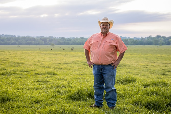Jonathan Perry posed in a pasture