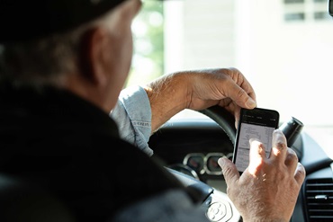 Rancher using cellphone to look up data