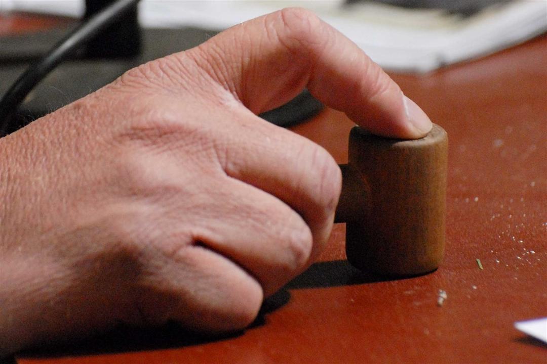 An auctioneer hitting his gavel on the block.