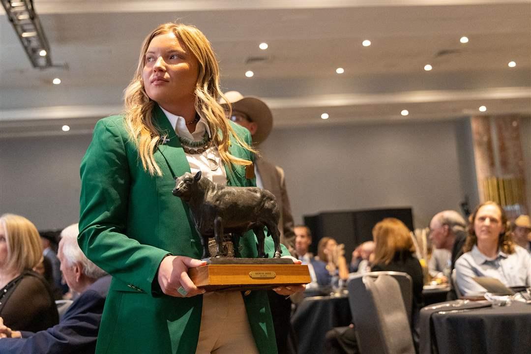National Junior Angus Association Director Lexi Koelling holds a historic bronze bull statue casted by artist Jim Reno and donated to the Angus Foundation’s live auction by past American Angus Association CEO, Jim Crouch. The Foundation raffle and Awards Dinner auction, during the 2025 Angus Convention in Kansas City, Missouri, collectively raised $37,320 to support education, youth and research.