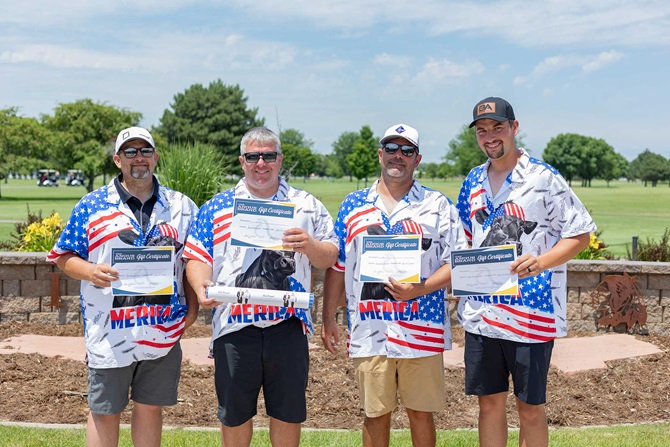 Group of four men on a golf tournament team.