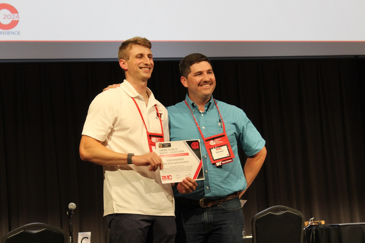 two men standing with award