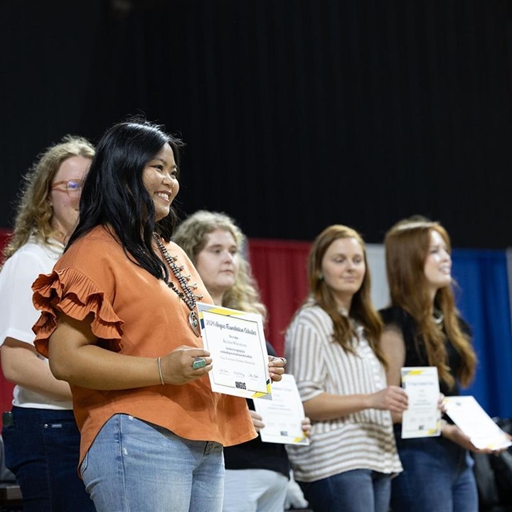 A female NJAA member being recognized with an award.