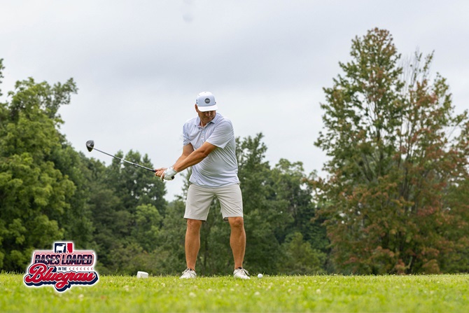 A participant tees off during the Bases Loaded in the Bluegrass golf tournament.