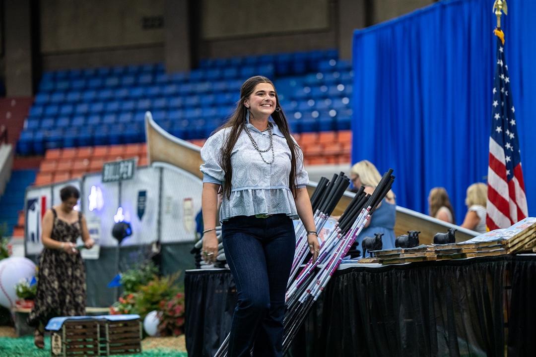 With a smile, Rosalind Kidwell of Gentryville, Indiana is recognized during the closing awards ceremony at the National Junior Angus Show in Tulsa, Oklahoma, marking the culmination of hard work and dedication throughout her junior career. 