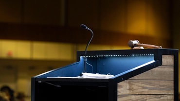 A podium lit up at the top of a stage.