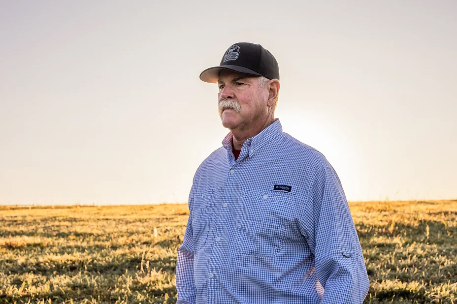 man in pasture at sunset 