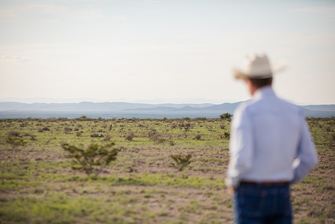 Texas landscape with a man in a cowboy hat