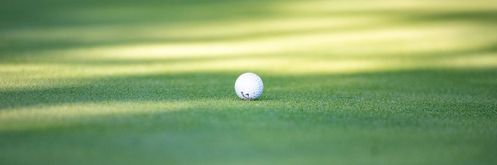 Callaway golf ball sitting on greens.